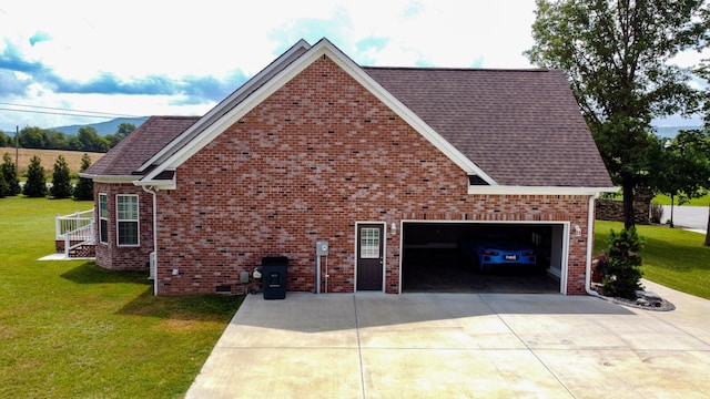 view of side of property with a lawn and a garage