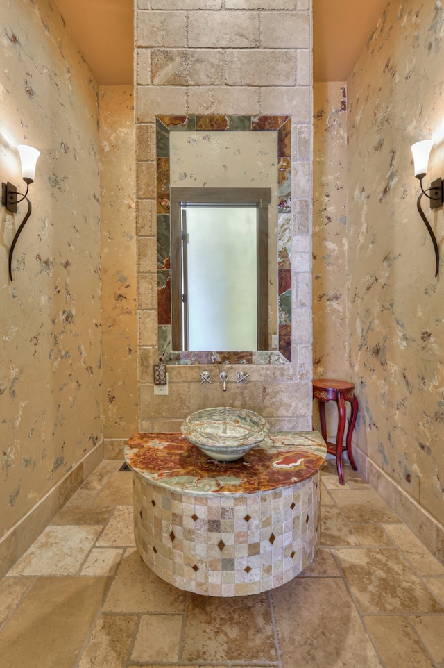 bathroom featuring tile walls, sink, tasteful backsplash, and tile flooring