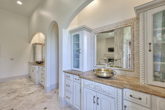 bathroom featuring baseboards and vanity