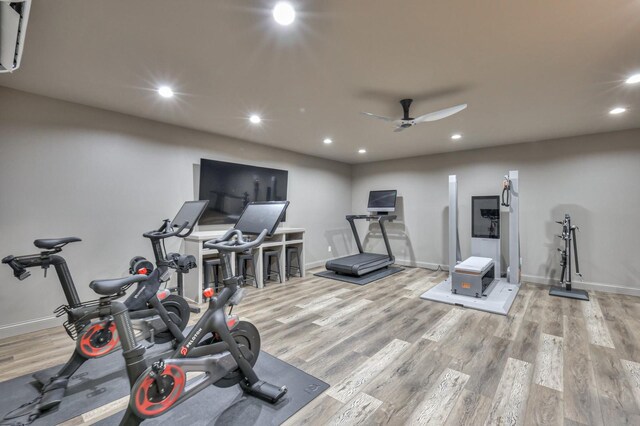 workout area featuring ceiling fan and light hardwood / wood-style flooring