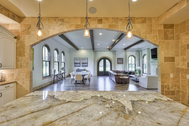 interior space with recessed lighting, arched walkways, beamed ceiling, and wood finished floors