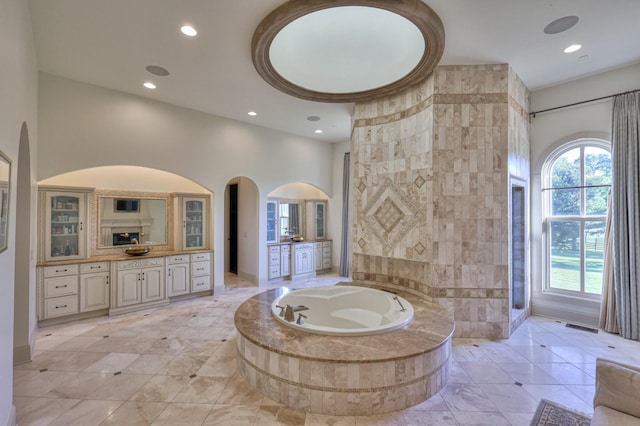 bathroom featuring visible vents, a garden tub, vanity, and recessed lighting