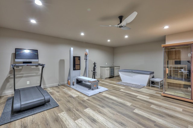 workout room with light wood-type flooring, ceiling fan, baseboards, and recessed lighting