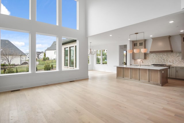 6051 Lookaway Cir, Franklin, TN 37067 - kitchen with premium range hood, open floor plan, light wood-style flooring, a kitchen island with sink, and recessed lighting