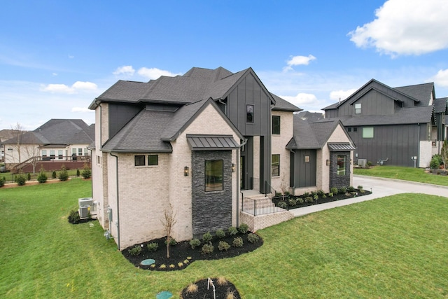 view of front of home with driveway, a residential view, roof with shingles, central AC, and a front yard