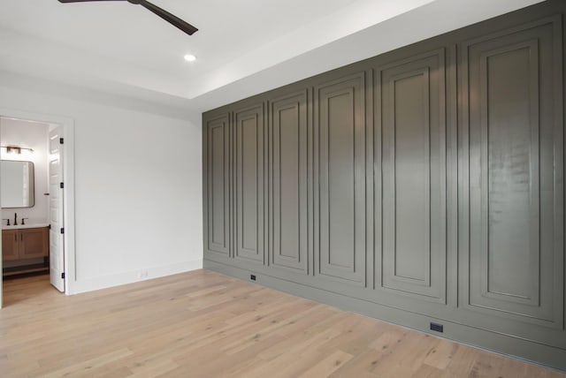 6051 Lookaway Cir, Franklin, TN 37067 - unfurnished bedroom featuring light wood-style flooring, ensuite bathroom, recessed lighting, a ceiling fan, and a tray ceiling