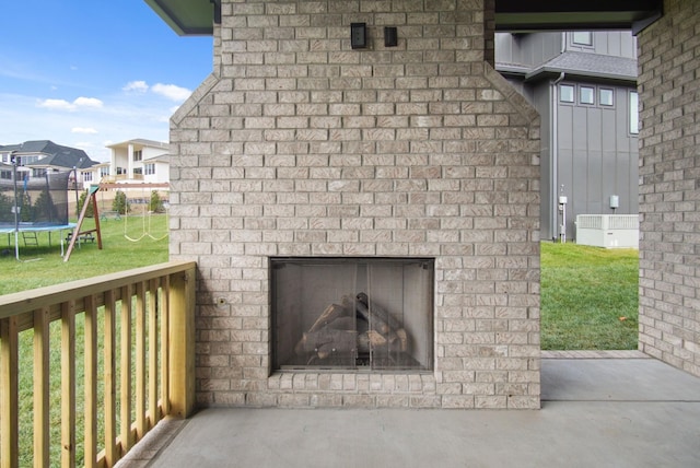 details with an outdoor brick fireplace, a residential view, and brick siding