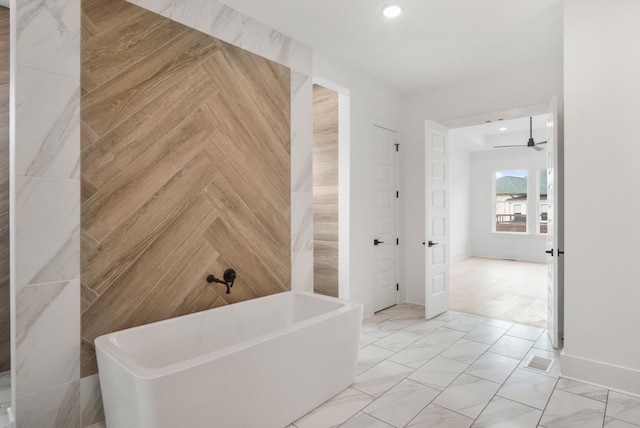 bathroom with baseboards, ceiling fan, marble finish floor, a freestanding bath, and recessed lighting