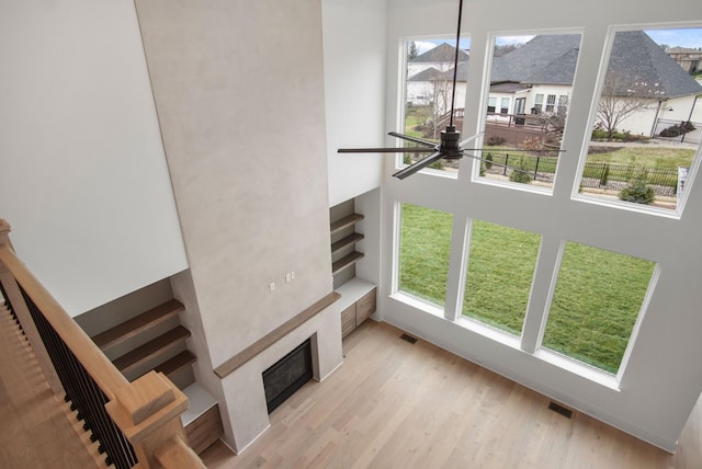 6051 Lookaway Cir, Franklin, TN 37067 - stairway featuring a ceiling fan, a fireplace, plenty of natural light, wood finished floors, and a high ceiling