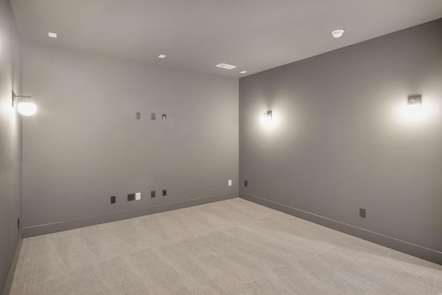 unfurnished room with light carpet, visible vents, and baseboards