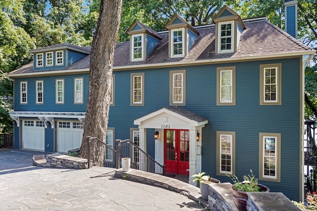 colonial-style house with french doors and a garage