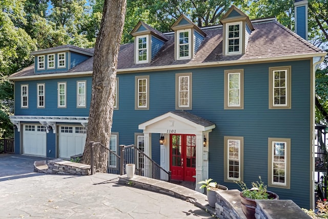 colonial-style house with french doors and a garage