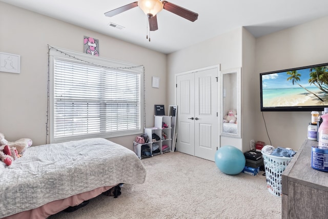 bedroom with carpet floors, ceiling fan, and a closet