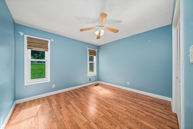 unfurnished bedroom featuring wood-type flooring and ceiling fan