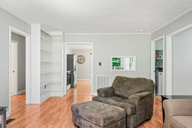 living room featuring light hardwood / wood-style floors and a textured ceiling