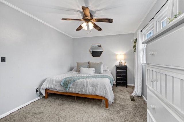 carpeted bedroom with ornamental molding and ceiling fan