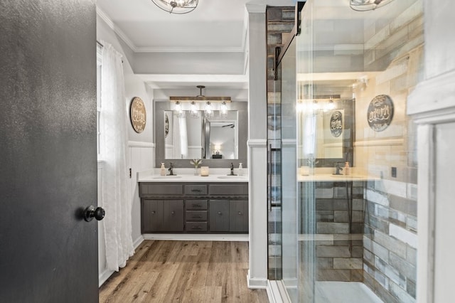 bathroom with ornamental molding, walk in shower, hardwood / wood-style floors, and dual bowl vanity