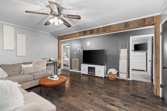 living room featuring dark hardwood / wood-style floors, ornamental molding, and ceiling fan