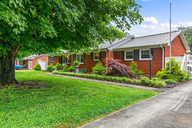 ranch-style home featuring a front yard