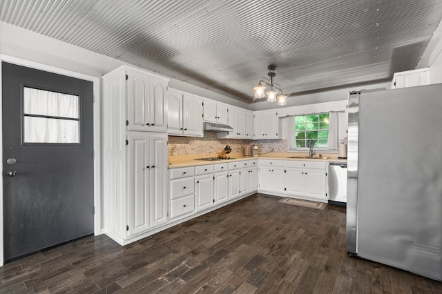 kitchen featuring white cabinetry, backsplash, stainless steel appliances, dark hardwood / wood-style floors, and sink