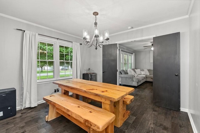 dining area featuring crown molding, dark wood-type flooring, and a chandelier