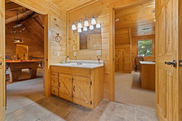 bathroom featuring wooden ceiling, vanity, lofted ceiling, and wooden walls