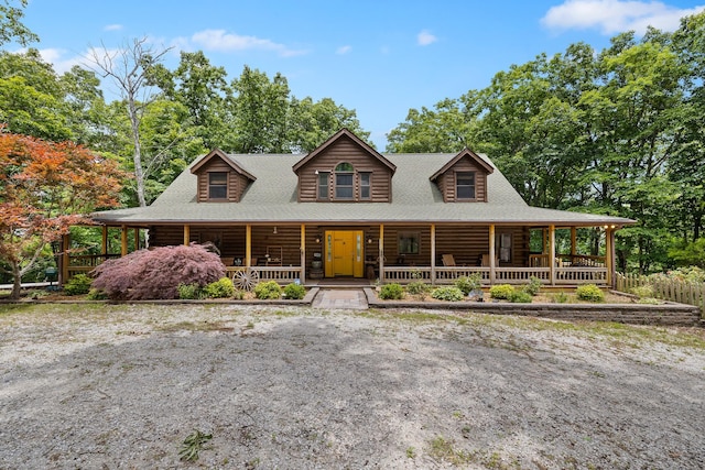 log-style house featuring covered porch