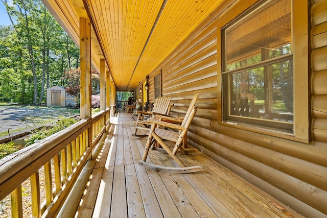 wooden deck featuring a storage shed