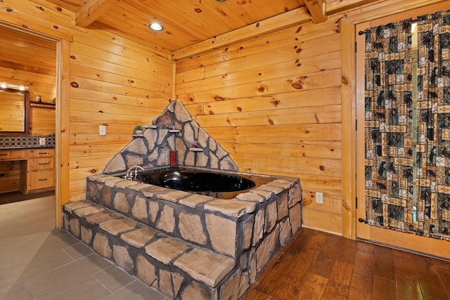 bedroom with wood ceiling, beamed ceiling, wooden walls, and dark hardwood / wood-style floors