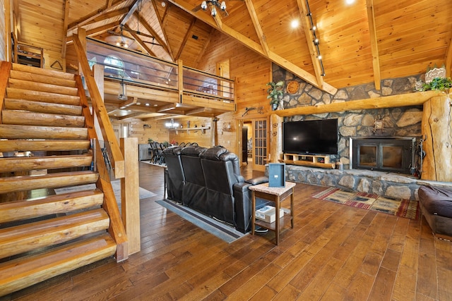 living room featuring beamed ceiling, a fireplace, wood ceiling, track lighting, and high vaulted ceiling