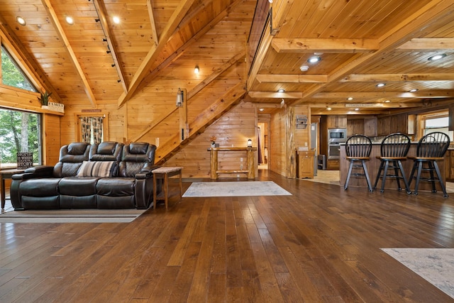 living room with beam ceiling, dark hardwood / wood-style flooring, wooden walls, and wooden ceiling