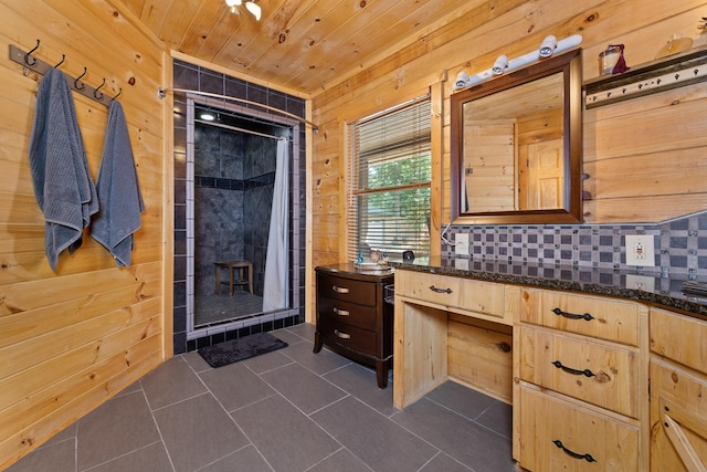 bathroom featuring a shower with curtain, vanity, wood ceiling, and wooden walls