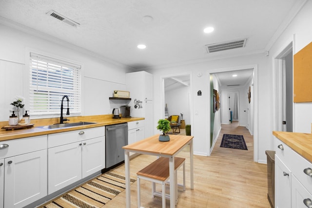 kitchen featuring dishwasher, wooden counters, white cabinets, sink, and light wood-type flooring