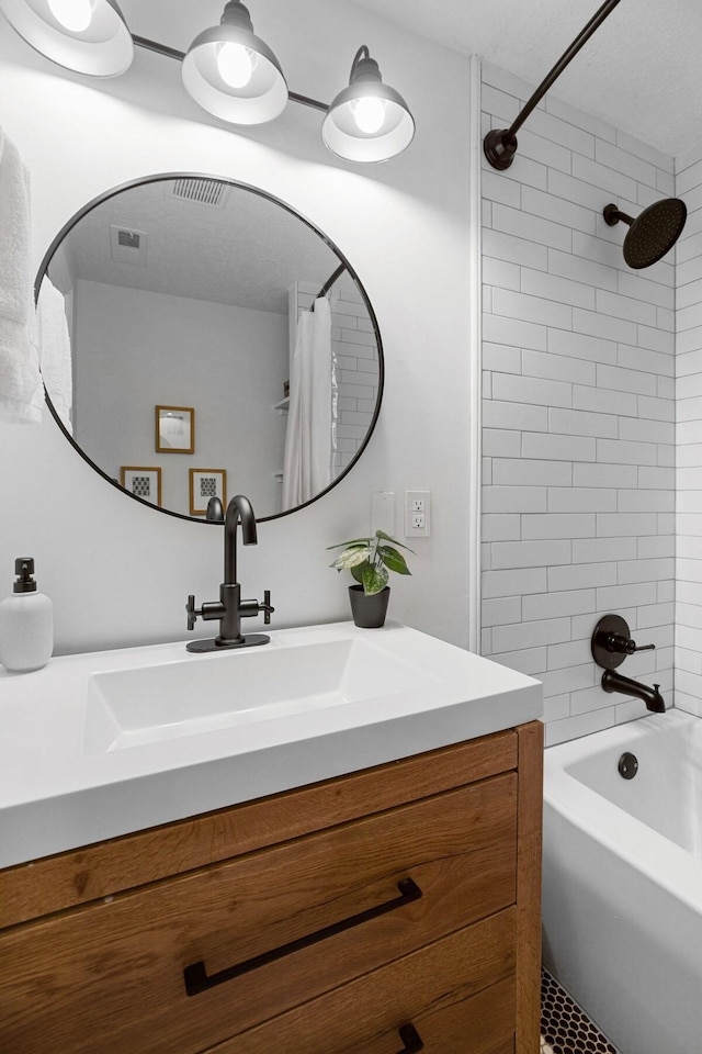 bathroom featuring vanity and shower / bath combo