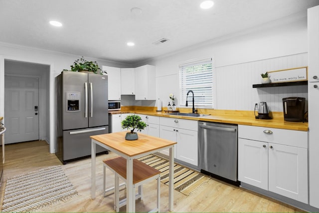 kitchen featuring white cabinetry, sink, appliances with stainless steel finishes, and wooden counters