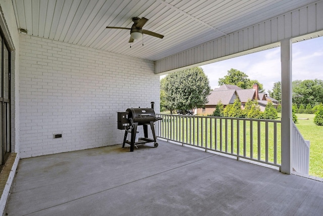 unfurnished sunroom with ceiling fan