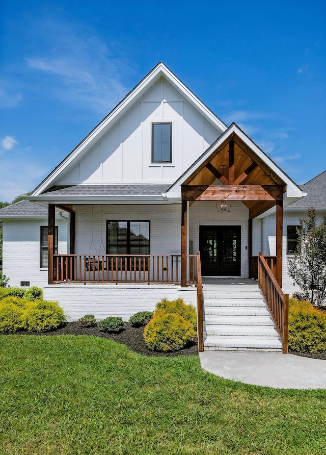 view of front of house featuring a front yard and a porch