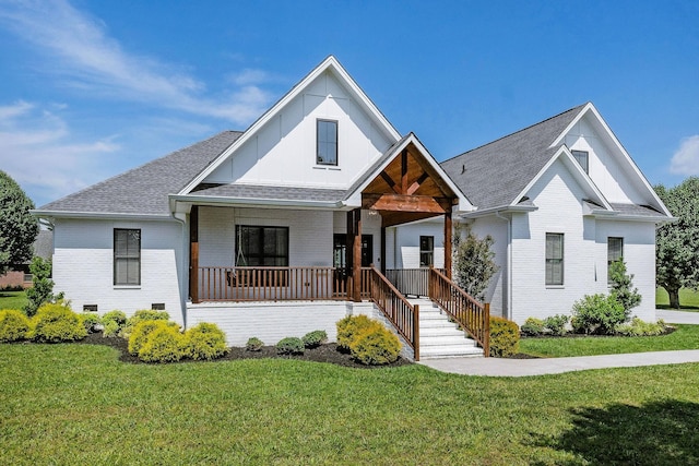 view of front of property with a porch and a front lawn