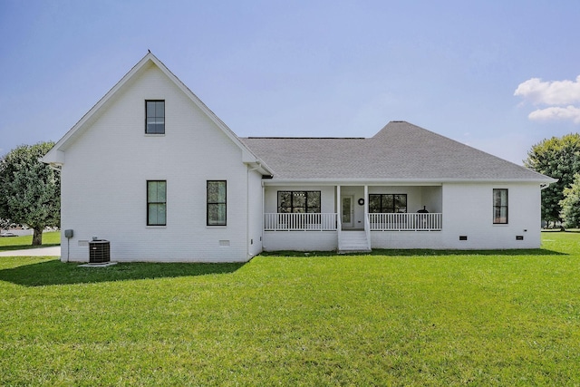 back of property featuring central AC unit, a porch, and a yard