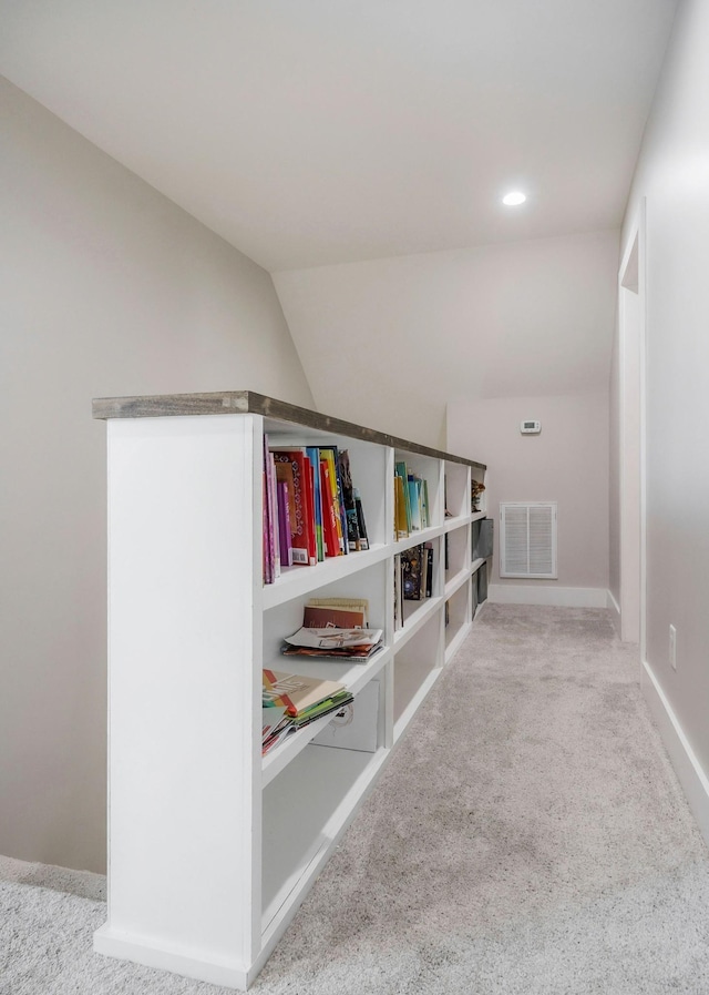 corridor featuring carpet floors and lofted ceiling