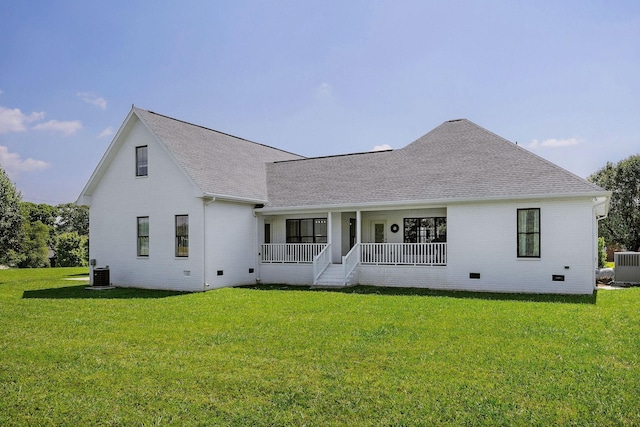 rear view of property featuring central AC unit, a porch, and a yard