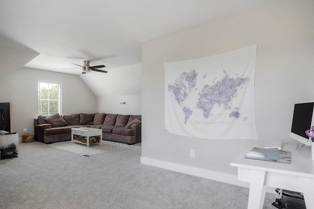 carpeted living room with ceiling fan and lofted ceiling