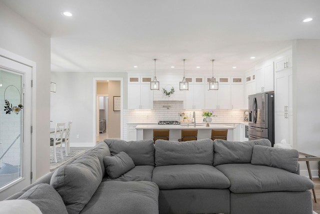 living room with sink and hardwood / wood-style flooring