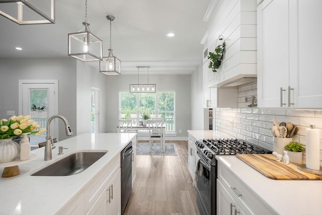 kitchen featuring black appliances, pendant lighting, and white cabinets