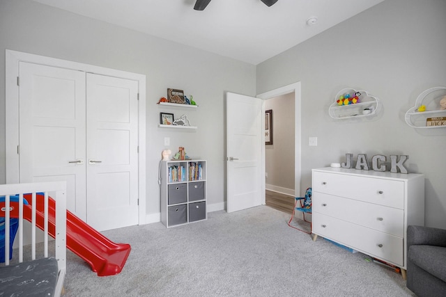 carpeted bedroom with ceiling fan and a closet