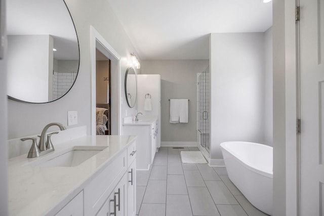 bathroom with plus walk in shower, vanity, and tile patterned flooring