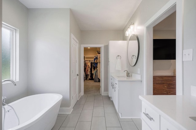 bathroom featuring vanity, a bathing tub, and tile patterned flooring