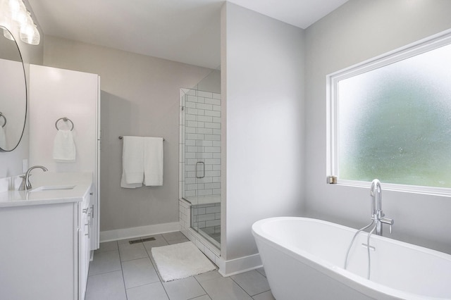 bathroom featuring independent shower and bath, tile patterned floors, and vanity