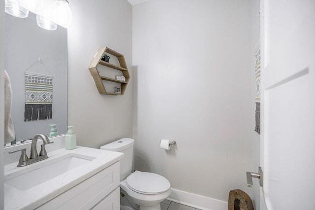 bathroom featuring toilet, vanity, and tile patterned flooring