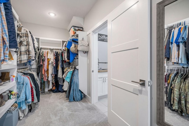 walk in closet featuring light carpet